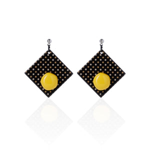 yellow handcrafted earrings on white background