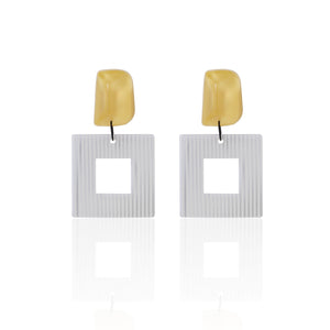 yellow handcrafted earrings on white background