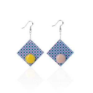 yellow and purple handcrafted earrings on white background